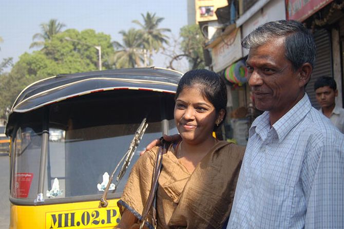 Jayakumar and Prema in front of the autorickshaw that Jayakumar drives.