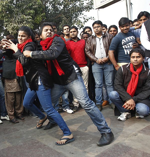 Demonstrators perform a street play on rape during a protest to mark the first anniversary of the Delhi gang rape