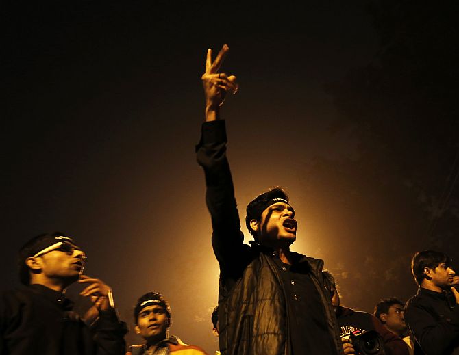 A protestor shouts slogans during a candle light vigil to mark the first anniversary of the Delhi gang rape