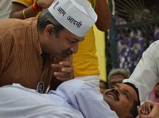 Mayank Gandhi, left, with Arvind Kejriwal.