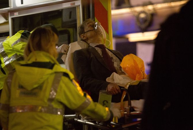 A man receives medical attention after part of the ceiling at the Apollo Theatre on Shaftesbury Avenue collapsed in central London.