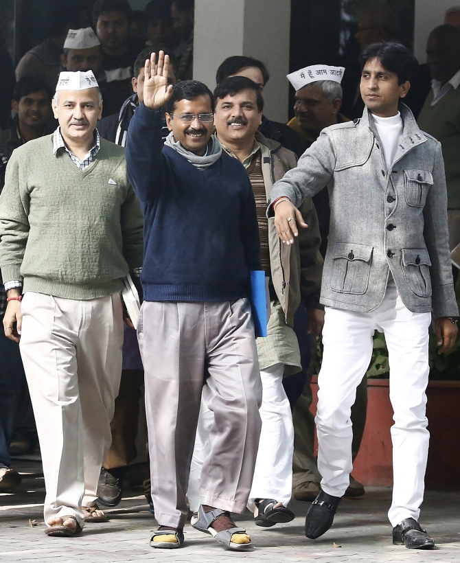Arvind Kejriwal, leader of the Aam Aadmi Party, waves after his meeting with the Delhi's Lieutenant Governor Najeeb Jung in New Delhi