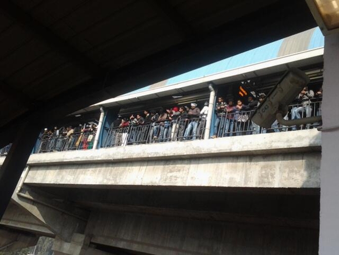 Crowds gather at a metro station in Delhi to get a glimpse of Kejriwal