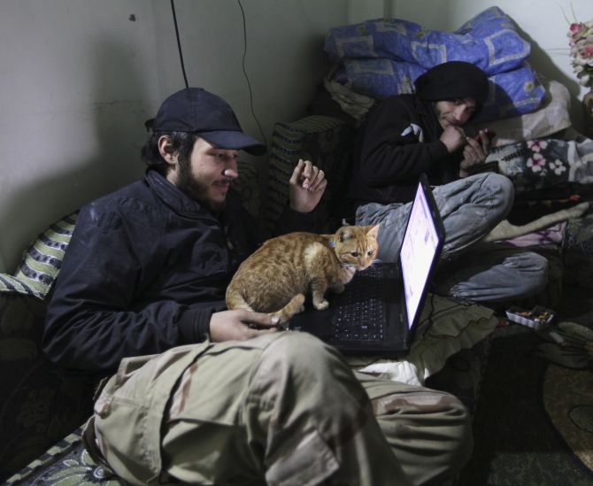 A Free Syrian Army fighter works on his computer in Deir al-Zor.