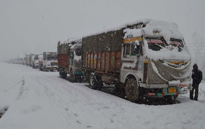 Trucks stranded outside Srinagar during heavy snowfall on Tuesday