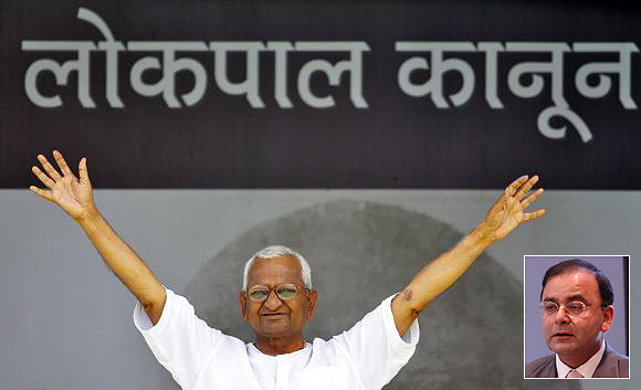 Social activist Anna Hazare waves to his supporters during a demonstration for strong Lokpal bill, at Ramlila Maidan in New Delhi (Inset) Arun Jaitley