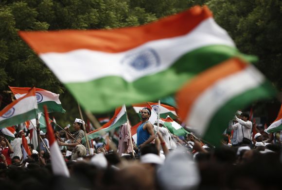 Supporters of Anna Hazare wave the national flag as they protest for a stronger Lokpal, in New Delhi