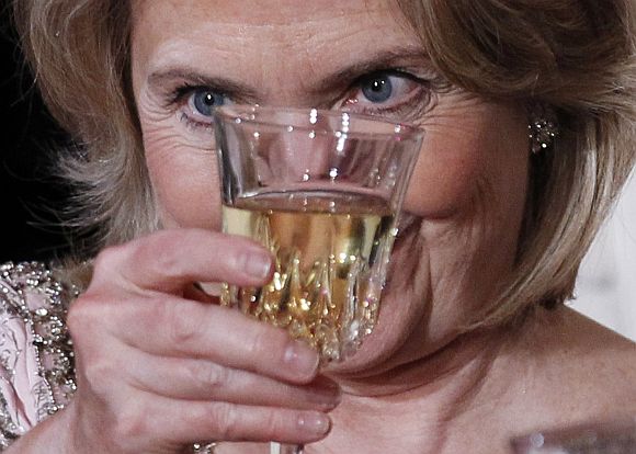 US Secretary of State Hillary Clinton raises her glass for a toast during a State Dinner