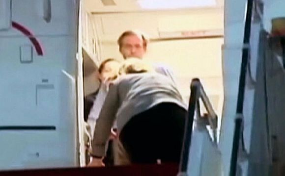 Hillary trips and falls to the floor while embarking her aircraft after completing a visit to Yemen. She was unhurt