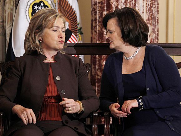 Hillary Clinton confers with Cherie Blair, wife of former British Prime Minister Tony Blair, at a State Department event to discuss international support for increasing women's access to mobile technology, at the State Department in Washington