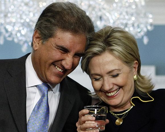 Hillary Clinton shares a laugh with former Pakistani Foreign Minister Shah Mehmood Qureshi after their meeting at the Sate Department in Washington, March 24, 2010
