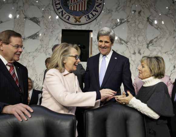 Clinton with Senator John Kerry prior to his confirmation hearing to replace her as secretary of state. Clinton is seen shaking hands with  Senator Barbara Boxer