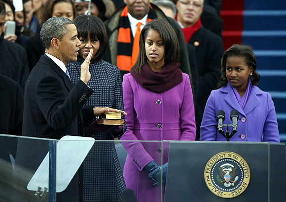 Barack Obama takes the oath before beginning his second term as president of the United States of America as his wife Michelle and daughters Malia and Sasha look on.