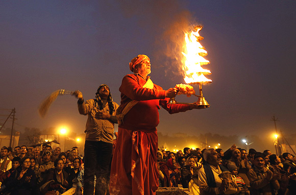 A priest performs the evening arti at the banks of the river Ganga/
