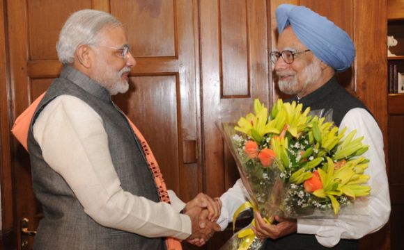 Modi greets Dr Manmohan Singh at the latter's residence in New Delhi on Wednesday