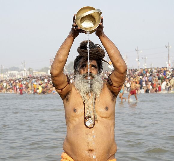 A sadhu prays after taking dip in the waters of the Ganga