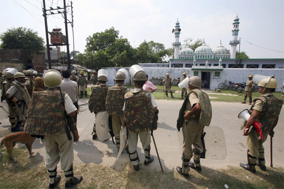 Paramilitary troopers stand guard outside a mosque in Ayodhya