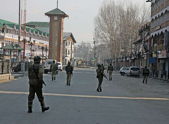 Security personnel patrolling a deserted street