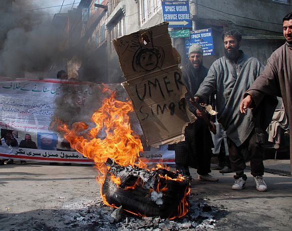 Protestors  burning a tyre at Afzal Guru's home town Sopore while protesting against Prime Minister Manmohan singh and Chief Minister Omar Abdullah