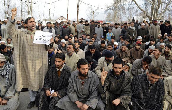 A person shouts slogans during a gathering to offer funeral prayers in absentia for Afzal Guru on a road on the outskirts of Srinagar on Saturday