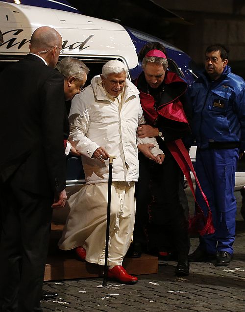 Pope Benedict XVI is helped as he arrives to attend a meeting with seminarians at the Romano Maggiore seminary in Rome