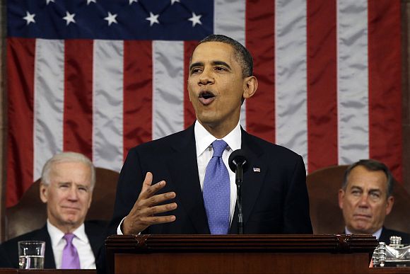 US President Barack Obama, flanked by Vice President Joe Biden and House Speaker John Boehner (R-OH), delivers his State of the Union speech before a joint session of Congress at the US Capitol