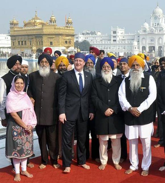 Britain's Prime Minister David Cameron poses inside the premises of the holy Sikh shrine the Golden temple in Amritsar.