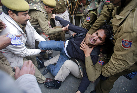 The police detain a demonstrator during a protest against the Delhi gang-rape