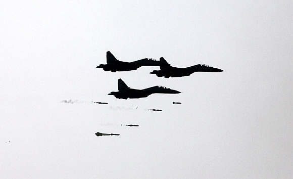 Three SU 30 MKI swing role fighter aircraft dropping bombs