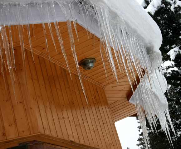 Icicles are formed on a rooftop of hut in Gulmarg