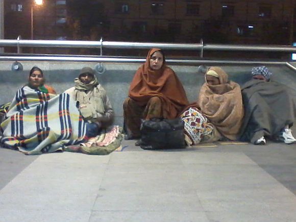 A group of people waiting outside AIIMS hospital, near the metro station