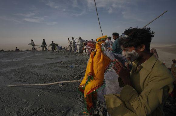 A Pakistani Hindu devotee prays at the crater of the Chandargup mud volcano in Balochistan province