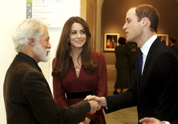 Glasgow-born artist Paul Emsley (L) greets Britain's Prince William (R) during a private viewing of his new official commissioned painting of Catherine, Duchess of Cambridge at the National Portrait Gallery in London