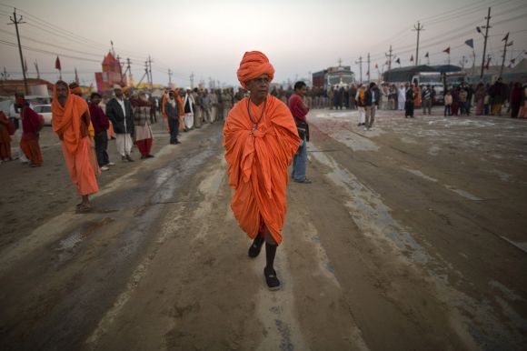 A Sadhu walks as he takes part in a religious procession near the banks of Ganga in Allahabad on Monday