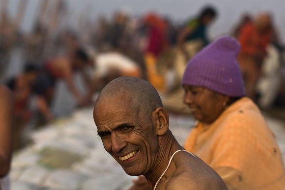 Devotees take part in the morning prayers on the banks of Ganga at the beginning of Kumbh Mela on Monday