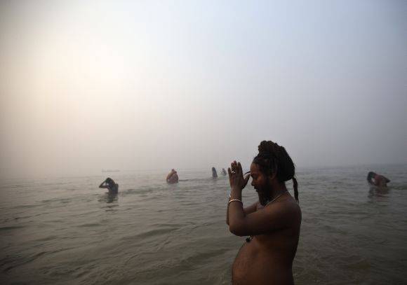 A Sadhu prays as he takes dip during first Shahi Snan at the ongoing Kumbh Mela in Allahabad