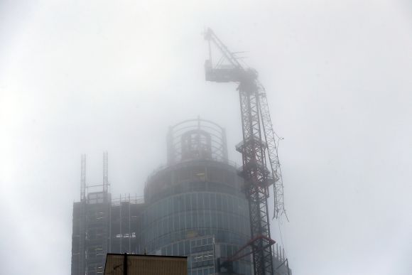 A damaged crane is seen on the St George's Tower in Vauxhall, after it was hit by a helicopter, in London on Wednesday