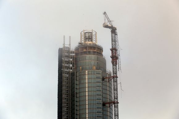 A damaged crane is seen on the St George's Tower in Vauxhall, after it was hit by a helicopter, in London on Wednesday
