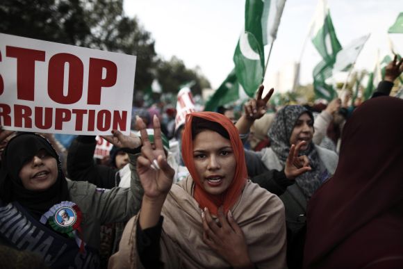 A supporter of Dr Qadri gestures as she takes part in a protest in Islamabad