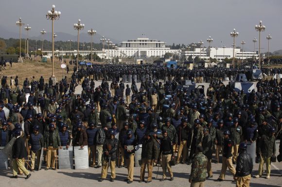 Riot police officers gather outside parliament during second day of protest by supporters Dr Qadri in Islamabad