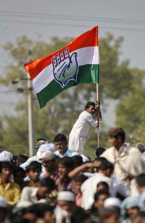 A supporter of the Congress Party holds onto a party flag