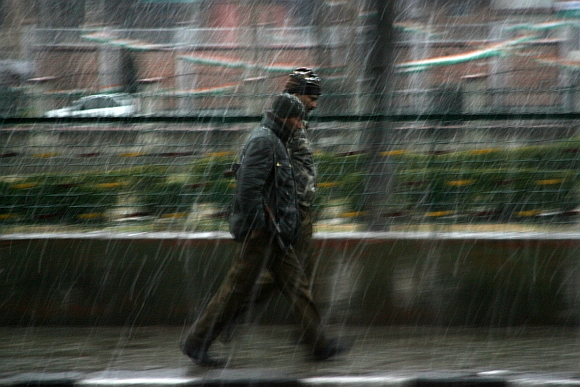 People hurry to the safety of their homes during the heavy snowfall