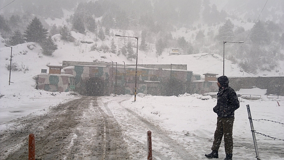 A security personnel stands guard at Jawahar Tunnel