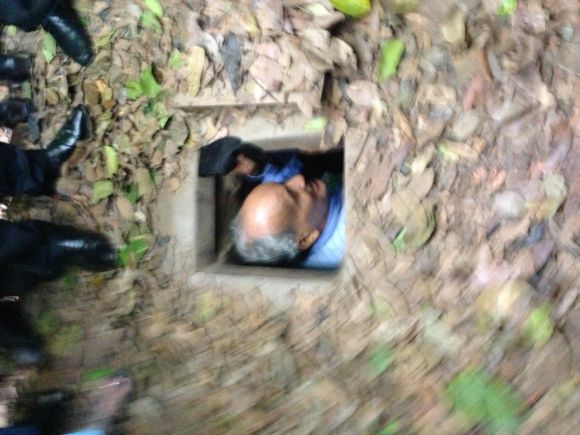 BJP leader B S Koshiyari tries to wiggle his way into a tunnel in Cu Chi