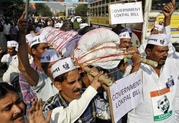 Supporters of social activist Anna Hazare carry a mock funeral pyre symbolising the government's anti-corruption Lokpal Bill during a demonstration in Ahmedabad