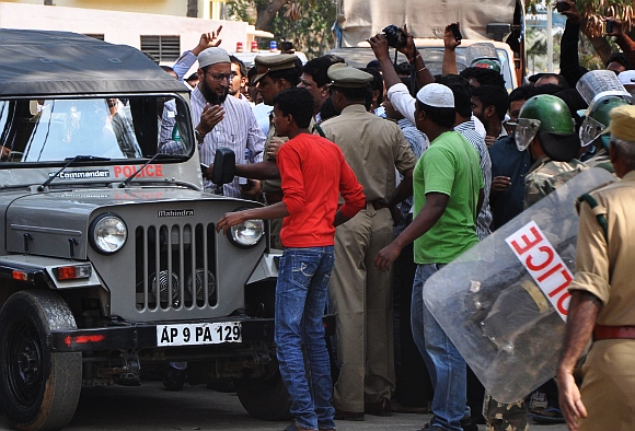 Asaduddin being led by a police escort