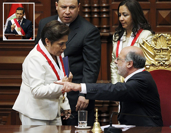 Peruvian congresswoman Luz Salgado (left) holds a copy of the current Constitution while arguing with Congress President Daniel Abugattas after the swearing in of (inset) Ollanta Humala as Peru's new president, in Lima