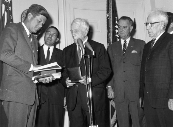 Robert Frost is presented with a medal by President John F Kennedy at the White House