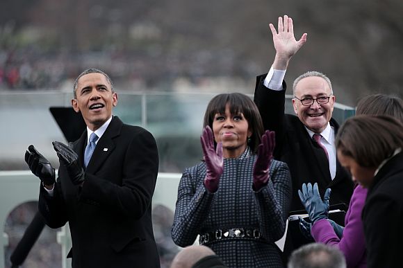 US President Barack Obama, First lady Michelle Obama and US Sen Charles Schumer (D-NY) clap