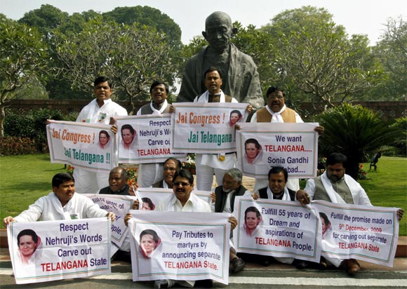 Political leaders hold posters demanding a seperate state of Telangana